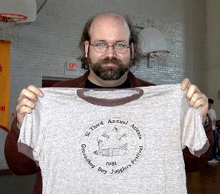 Rick Purtee holds a vintage t-shirt from the festival in 1981