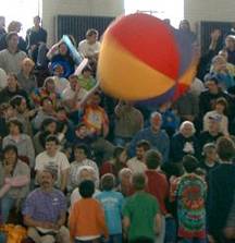 audience for the competition plays with the big beach ball